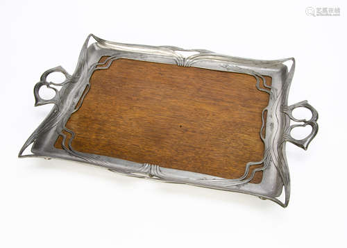 A continental Art Nouveau twin handled pewter and pine tray, the wooden base surrounded by a frame