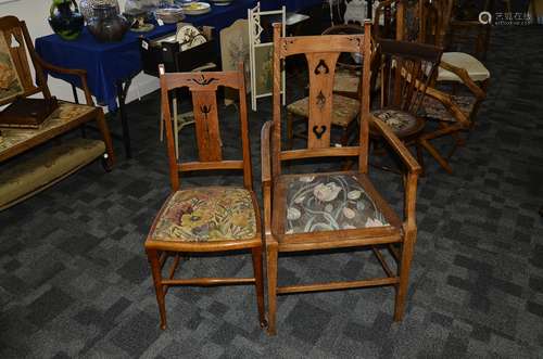 An Arts and Crafts oak armchair, with pierced back splat and back rail above a later floral