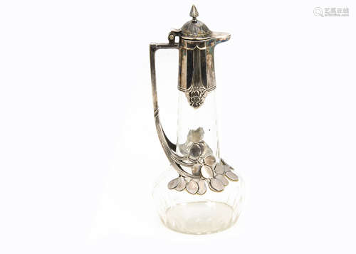 A WMF silver plated on pewter and cut glass claret jug, the colourless glass base with oval roundels