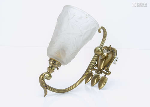 A brass Art Nouveau wall light applique, the brass bracket decorated with three stylised floral