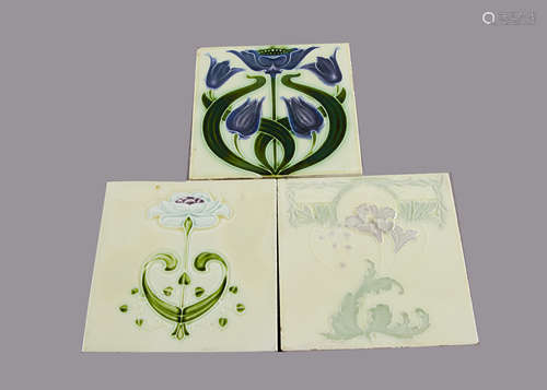 Three Alfred Meakin relief moulded Art Nouveau tiles, all with purple flowers, 15cm square One