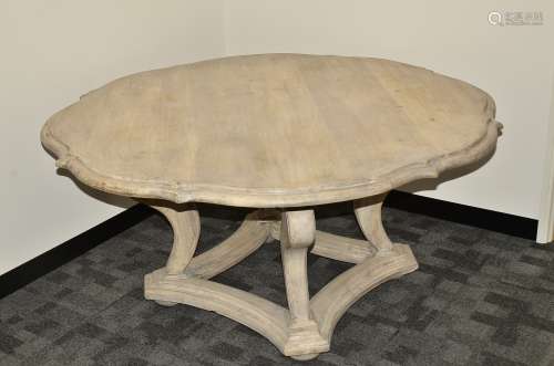 A contemporary limed oak Tudor Rose dining table, of shaped form on four large scroll cabriole