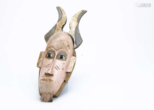 A Senufo painted mask, Ivory Coast, length 40cm