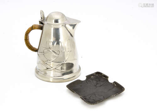 A Tudric pewter hot water jug, designed by Archibald Knox, the tapered body with flower heads and