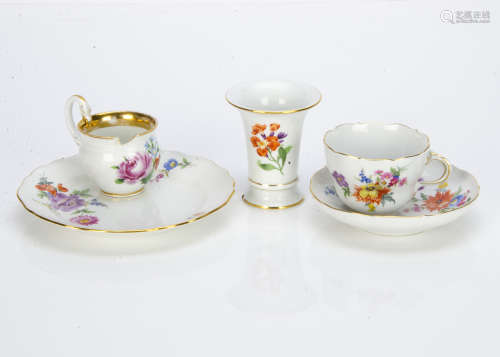 A Meissen porcelain trio, the cup, saucer and side plate with floral spray decoration painted in