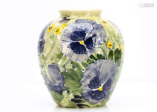 A contemporary Jonathan Cox ovoid vase, decorated with tubelined pansies, in blue with yellow