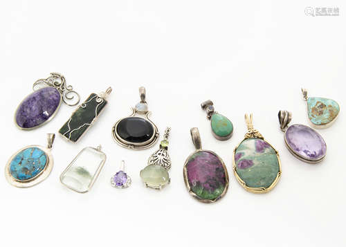 A collection of hardstone pendants, including three turquoise set in silver, an amethyst matrix in