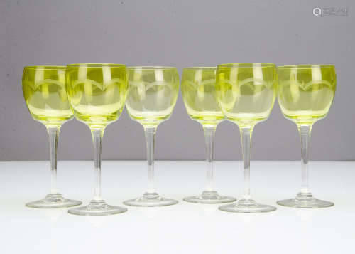 A set of six continental early 20th Century green bowled wine glasses, with wheel engraved arched