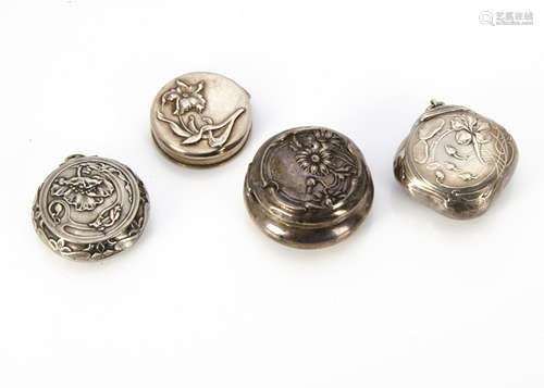 A French Art Nouveau white metal miniature hinged circular box, with embossed decoration of poppy