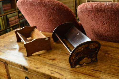 A stained beech Art Nouveau book trough, of shaped end supports with floral and sinuous stem