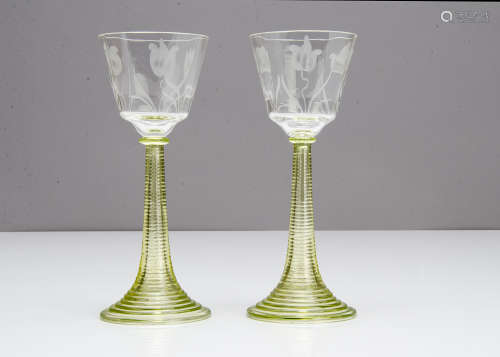 A pair of continental engraved Art Nouveau wine glasses, the tapered bowls with stylised floral