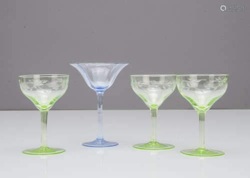 A set of three green engraved Art Nouveau liquor glasses, 10cm high together with a blue optic