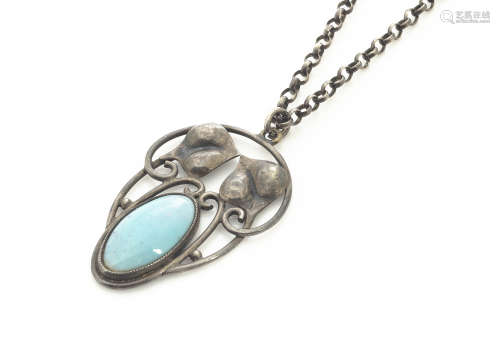 A white metal and turquoise Art Nouveau oval pendant, stylised leaf design centred with oval