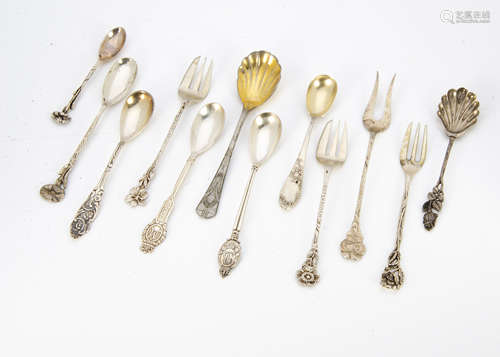 A collection of white metal, silver and silver plated spoons, all with floral terminals, some set