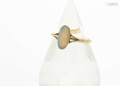 An 18ct gold opal dress ring, the elongated precious oval opal in rubbed over setting with pierced