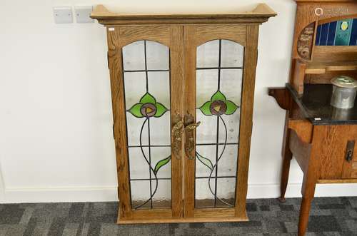 A contemporary oak and glazed panelled display cabinet, the glazed Art Nouveau lead lined panels