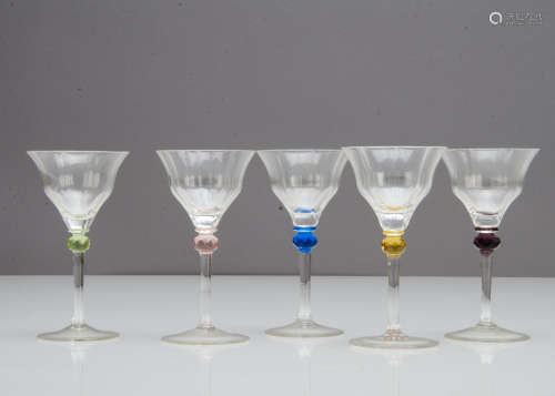 A set of five continental cocktail glasses, each with a moulded trumpet bowl having a harlequin