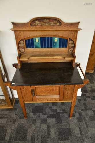 An Arts and Crafts oak tiled back marble topped washstand, the stylised blue, yellow and green tiled