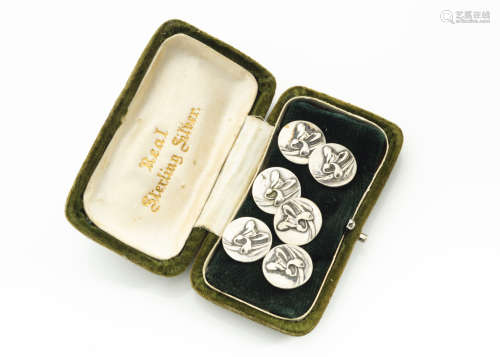 A set of six continental Art Nouveau white metal circular buttons, with stylised irises in relief