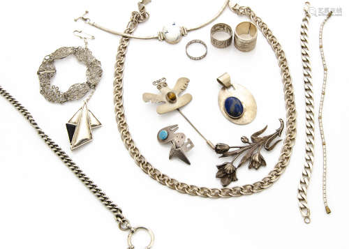 A collection of white metal and silver jewellery, including a Mexican and tiger's eye pin brooch,