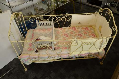 An iron painted child's cot, circa 1900, 61cm wide x 130cm x 89cm high, with contemporary Winnie the