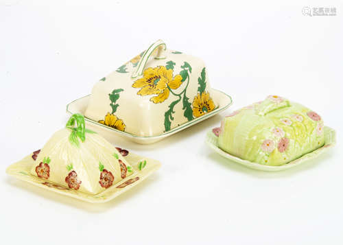 Three Art Deco pottery butter dishes and covers, comprising a Burlington Pottery example with red