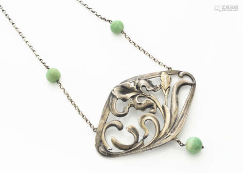A continental white metal Art Nouveau jade set pendant necklace, the lozenge shaped pendant with