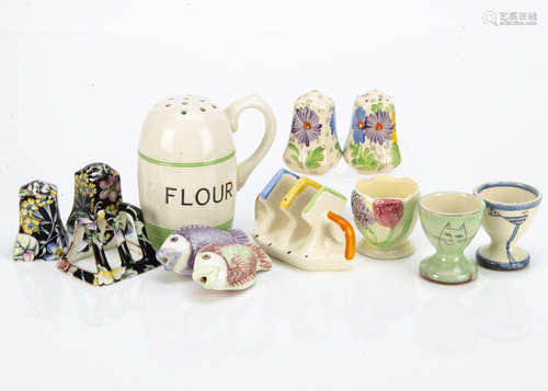 A collection of Art Deco kitchenware items, including a Kleen Kitchenware flour shaker with high