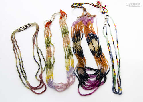 A collection of multi strand corundum bead necklaces, in various colours ranging from rubies,