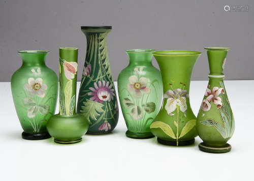 Six Art Nouveau green glass vases, all with painted decoration including a pair of ovoid vases