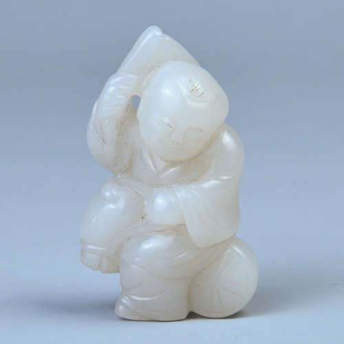 A HETIAN WHITE JADE BOY-SHAPED HANDLE PIECE MADE OF SEED MATERIAL