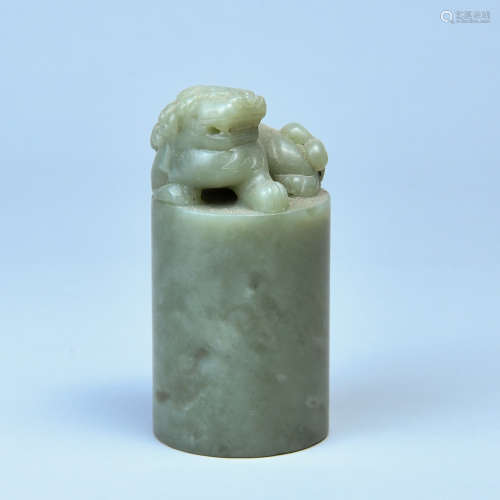 A HETIAN GREEN-AND-WHITE JADE LION-SHAPED SEAL