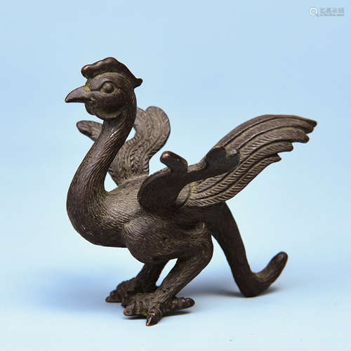 A COPPER BIRD-SHAPED ORNAMENT