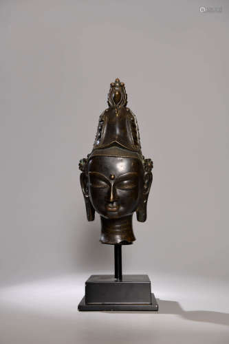 A CHINESE COPPER BUDDHA HEAD ORNAMENT