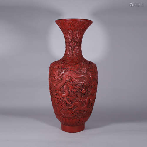 A CHINESE CARVED RED LACQUER VASE WITH DRAGON PATTERN