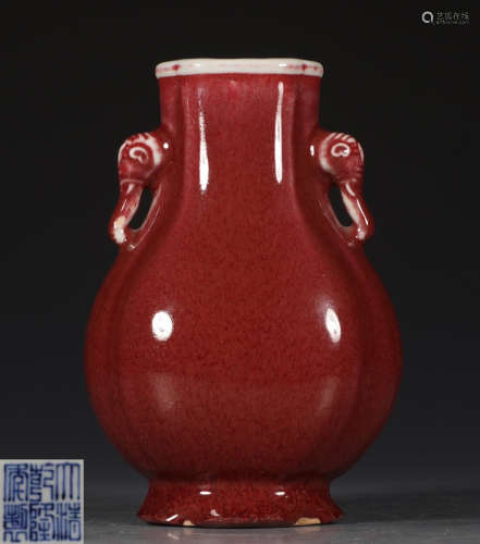 A RED GLAZE VASE WITH ERAS