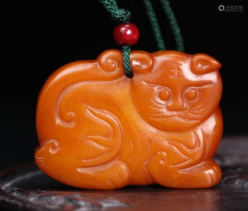 A YELLOW JADE PENDANT CARVED WITH TIGER