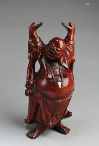 A Carved Wooden Deity Figurine
