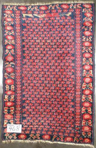 Handmade wool rug with red and pink floral decorat…