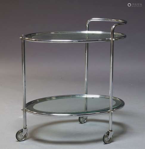 An Art Deco chrome and glass two tier trolley, c.1940, with two oval glass and mirrored tiers, on