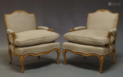 A pair of reproduction Louis XV style beech fauteuils, of recent manufacture, each with cartouche