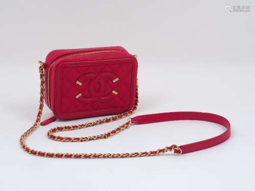 A Chanel clutch bag, the rectangular form red leather body designed with Chanel logo and matelassé