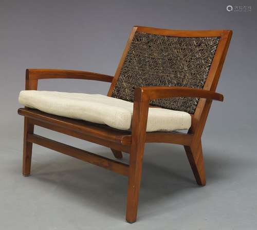 A modern teak armchair, of recent manufacture, with woven leather backrest above seat with loose