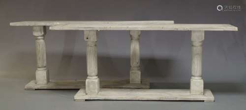 A pair of white painted console tables, of recent manufacture, the rectangular tops on turned and