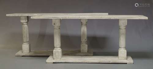 A pair of white painted console tables, of recent manufacture, the rectangular tops on turned and