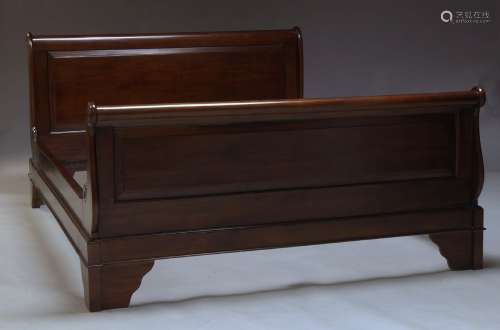 A mahogany double bed, of recent manufacture, with panelled headboard and footboard, flanked by s-