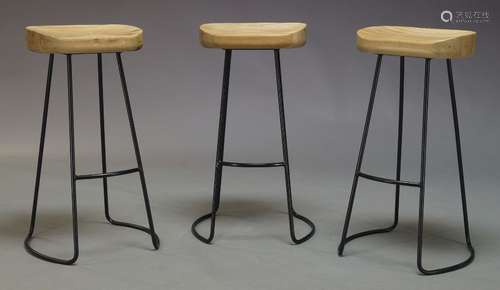 A set of three contemporary bar stools, with shaped oak seats, on black anodized steel rod frame (