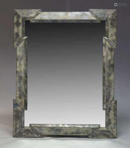 A contemporary wall mirror, of recent manufacture, with raised geometric and reverse painted border,