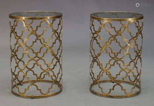 A pair of gilt metal side tables, of recent manufacture, with circular glass tops on cylindrical