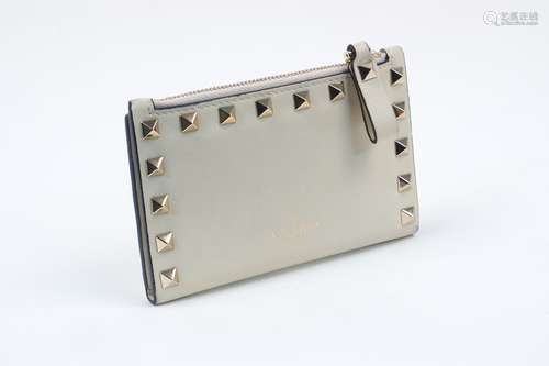 A Valentino Garavani 'Rockstud' calfskin leather purse, the folding body with six card holder slots,